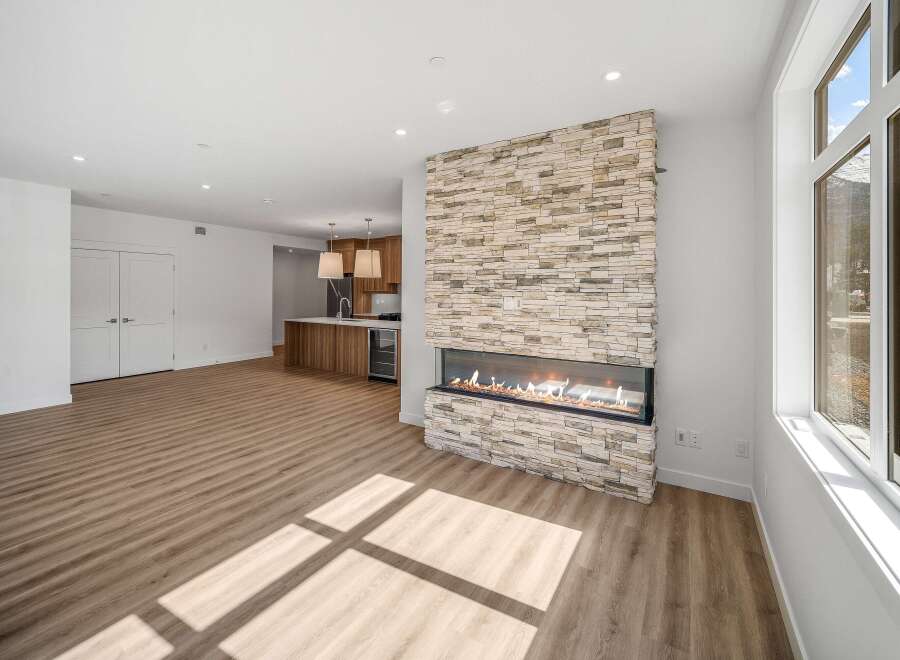 Experience luxury living in this stunning property! Featuring a modern fireplace with a stone facade, this home exudes warmth and sophistication.