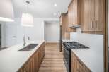 Step into this stunning kitchen, featuring sleek countertops and modern cabinetry.