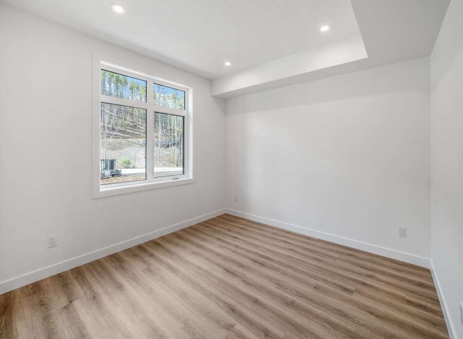 This bright and airy room features a large window that offers stunning views of the surrounding landscape.