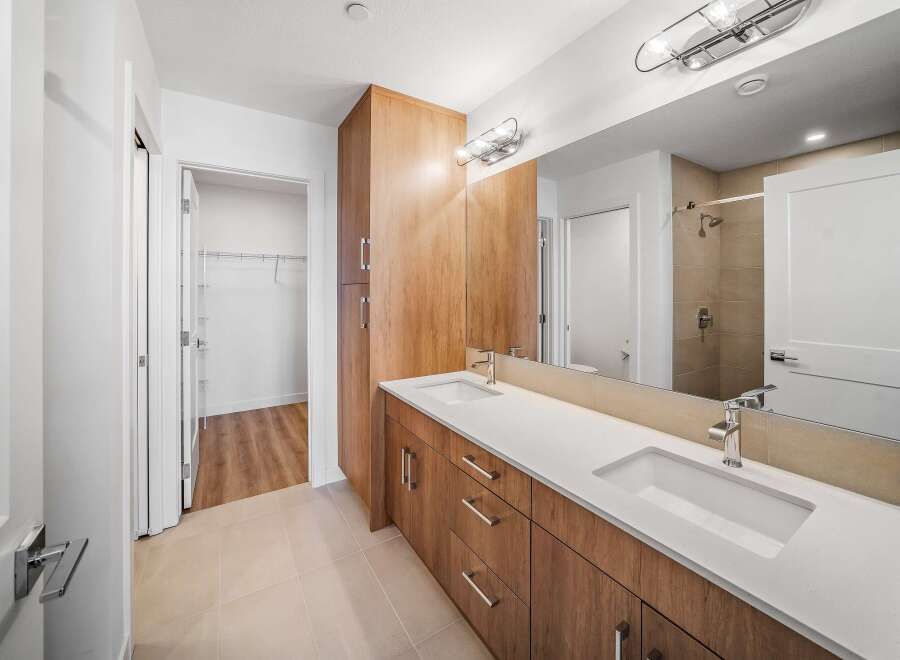 This stunning bathroom boasts a modern design with a sleek vanity and ample storage.