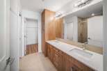 This stunning bathroom boasts a modern design with a sleek vanity and ample storage.