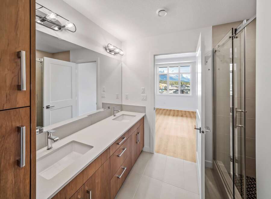 Step into luxury with this stunning bathroom featuring a sleek double vanity and modern fixtures.