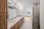 Step into luxury with this stunning bathroom featuring a sleek double vanity and modern fixtures.