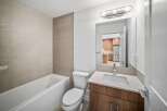 This modern bathroom features a sleek design with a combination of functionality and style.