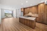 This stunning kitchen boasts modern design with sleek cabinetry and a spacious island, perfect for culinary enthusiasts.