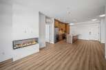 Experience modern living in this stunning property featuring a sleek fireplace and a contemporary kitchen.
