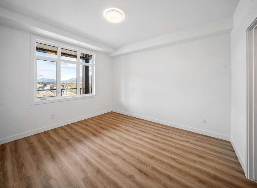 This bright and airy room features a large window that offers stunning views.