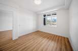 This bright and airy room features stunning mountain views through large windows, creating a serene atmosphere.