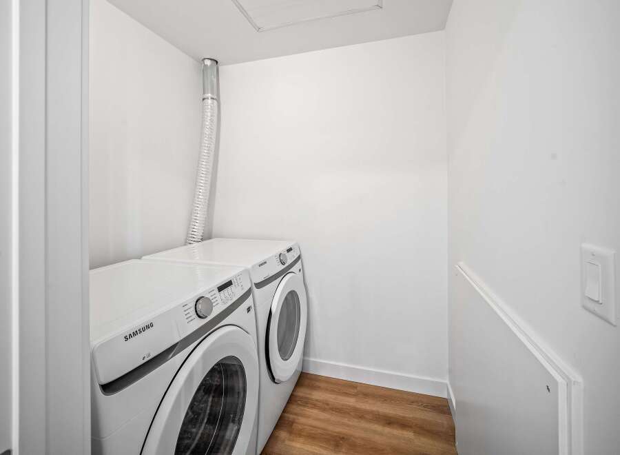 This modern laundry room features a sleek Samsung washer and dryer set, perfect for efficient and stylish laundry days.
