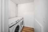 This modern laundry room features a sleek Samsung washer and dryer set, perfect for efficient and stylish laundry days.