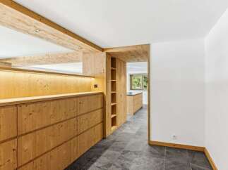 This stunning property boasts a beautifully designed interior with natural wood accents throughout.