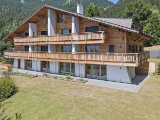 Discover the charm of this stunning wooden chalet nestled in a picturesque mountain setting.