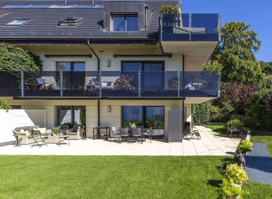 Discover luxury living in this stunning property featuring multiple balconies with glass railings, perfect for enjoying the outdoors.