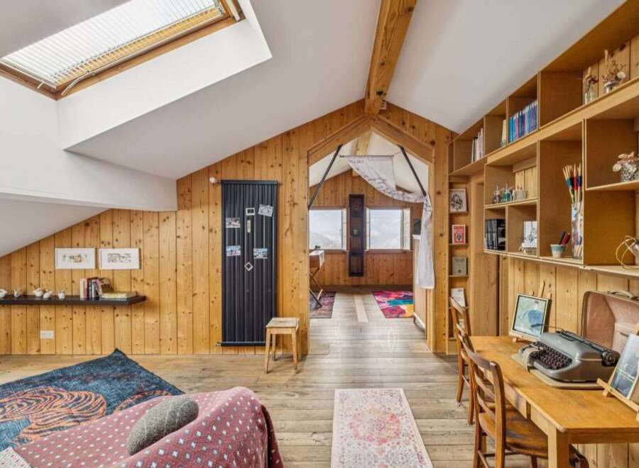 This charming property boasts a unique, rustic interior with wooden paneling and a cozy atmosphere.