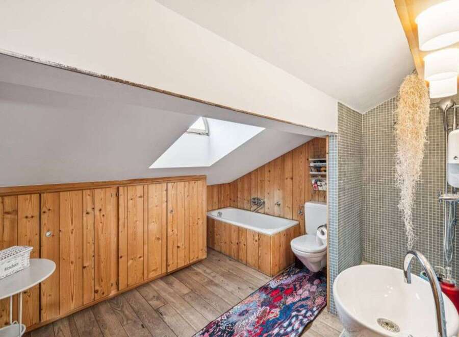 Discover the charm of this unique bathroom, featuring a skylight that floods the space with natural light.
