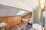 Discover the charm of this unique bathroom, featuring a skylight that floods the space with natural light.