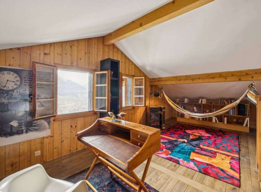 Discover the charm of this unique property, featuring a cozy reading nook and a stylish desk area.