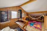 Discover the charm of this unique property, featuring a cozy reading nook and a stylish desk area.