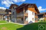 Discover your dream alpine retreat! This stunning property boasts a modern design with wooden accents, offering a warm and inviting atmosphere.
