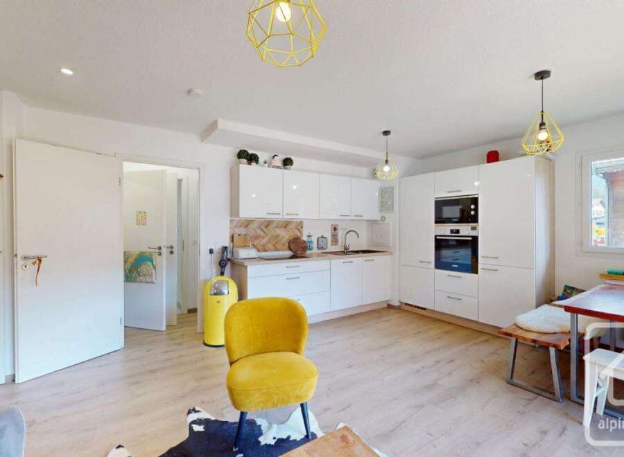 Discover this stunning property featuring a modern kitchen with sleek white cabinetry and integrated appliances.