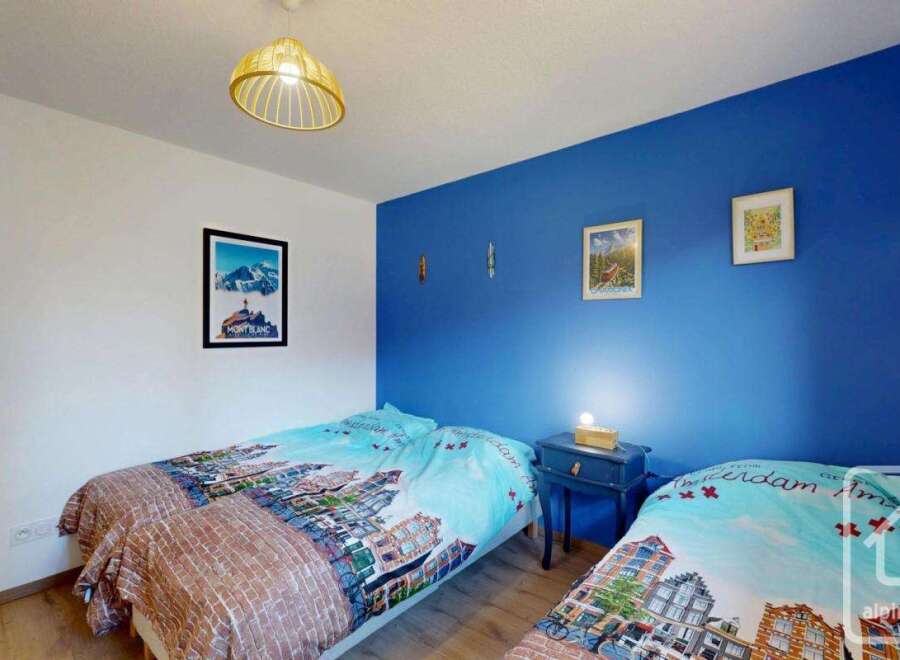 Discover this charming bedroom featuring two cozy beds, perfect for guests or family.
