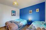 Discover this charming bedroom featuring two cozy beds, perfect for guests or family.
