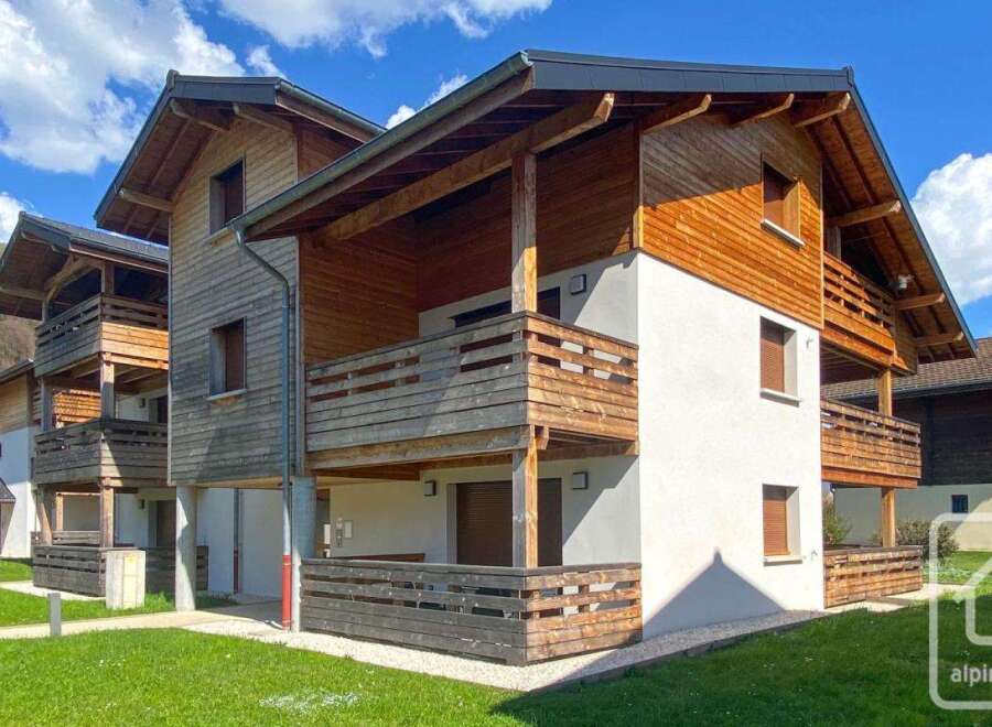 Discover the charm of this stunning property, featuring a beautiful wooden facade and inviting balconies.