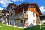 Discover the charm of this stunning property, featuring a beautiful wooden facade and inviting balconies.