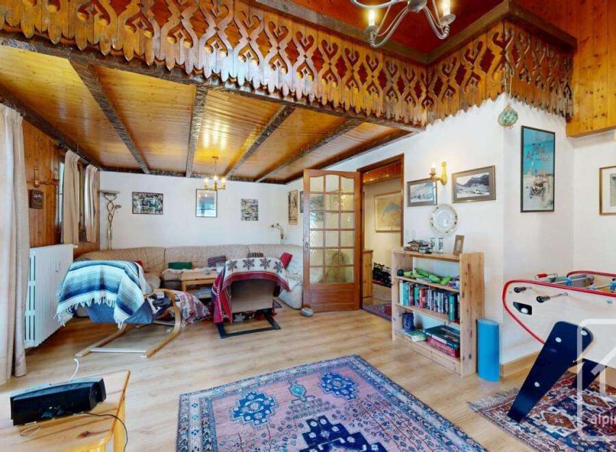 Step into a cozy living space with a unique wooden ceiling design, creating a warm and inviting atmosphere.
