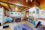 Step into a cozy living space with a unique wooden ceiling design, creating a warm and inviting atmosphere.