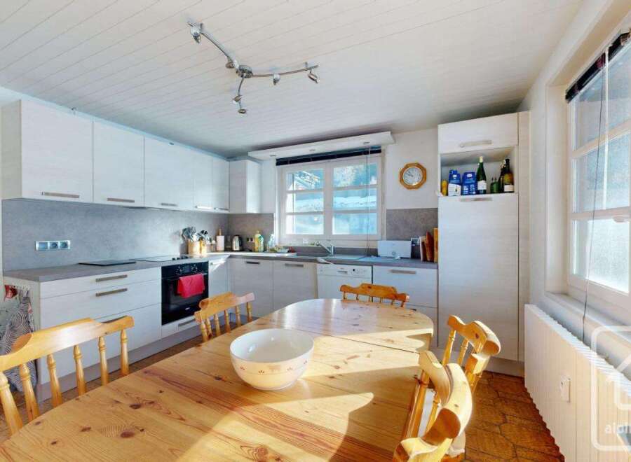 This charming kitchen features a warm, inviting dining area perfect for family meals.