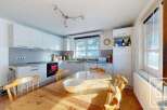 This charming kitchen features a warm, inviting dining area perfect for family meals.
