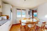 This charming kitchen features a cozy dining area with a wooden table and chairs, perfect for enjoying meals with family and friends.