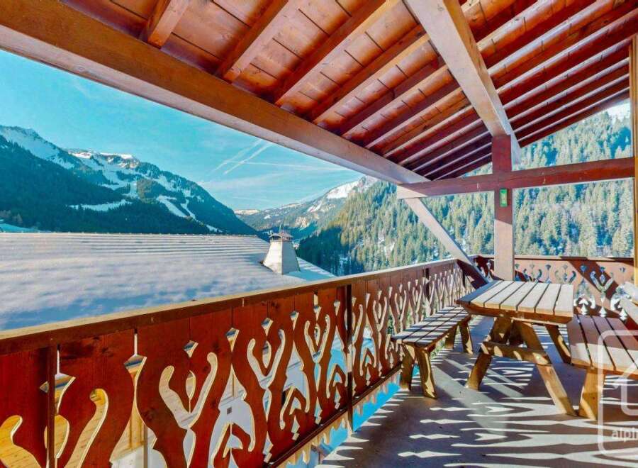 Enjoy breathtaking mountain views from this charming chalet balcony.