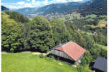 Nestled in a picturesque mountain landscape, this charming property offers a tranquil retreat.