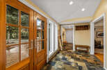 Step into this inviting entryway, showcasing a stunning wooden double door that welcomes you.
