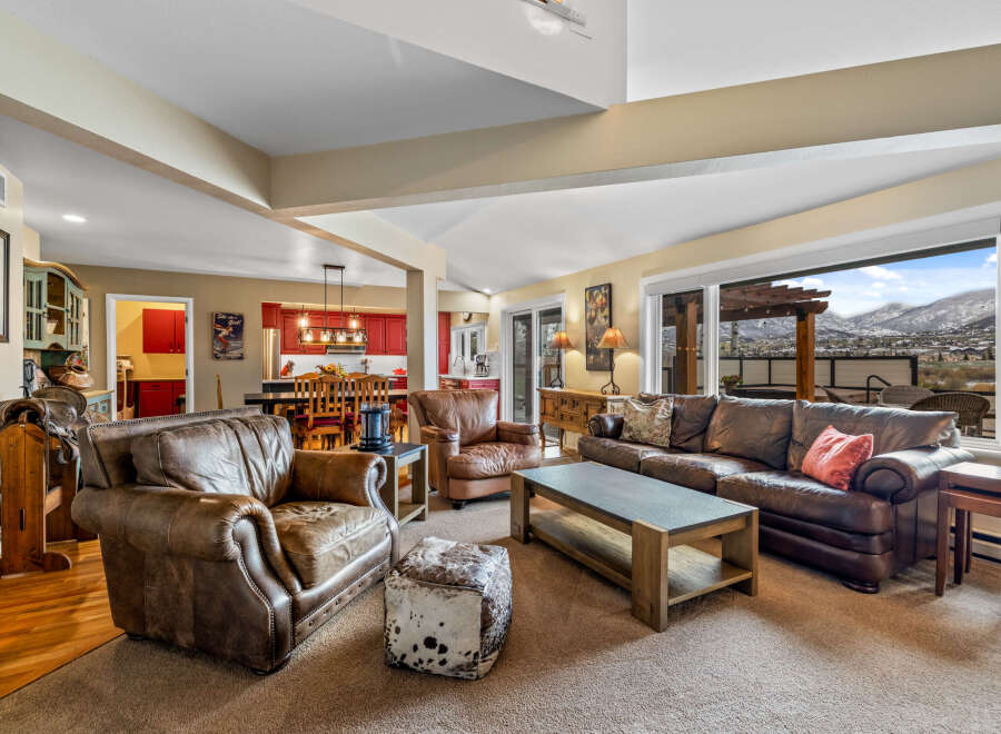 This stunning living room boasts a cozy atmosphere with its plush leather seating and inviting layout.