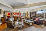 This stunning living room boasts a cozy atmosphere with its plush leather seating and inviting layout.