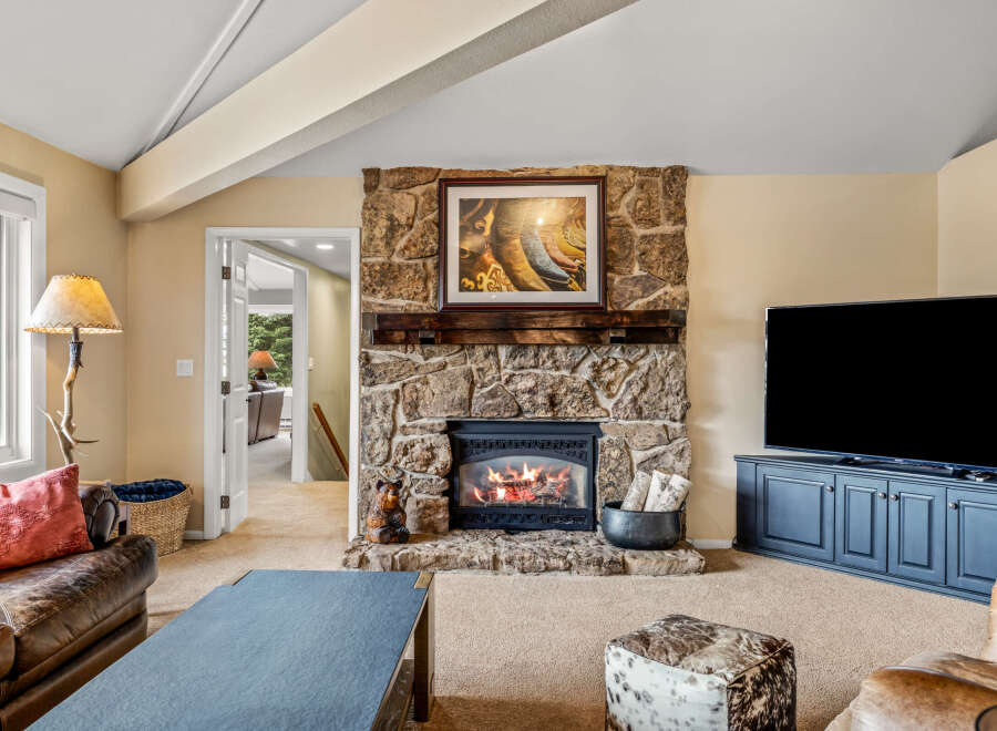 This stunning property boasts a cozy living room with a stone fireplace, perfect for those chilly evenings.