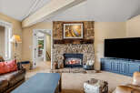This stunning property boasts a cozy living room with a stone fireplace, perfect for those chilly evenings.