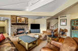 This stunning living room boasts a cozy stone fireplace, perfect for chilly evenings.