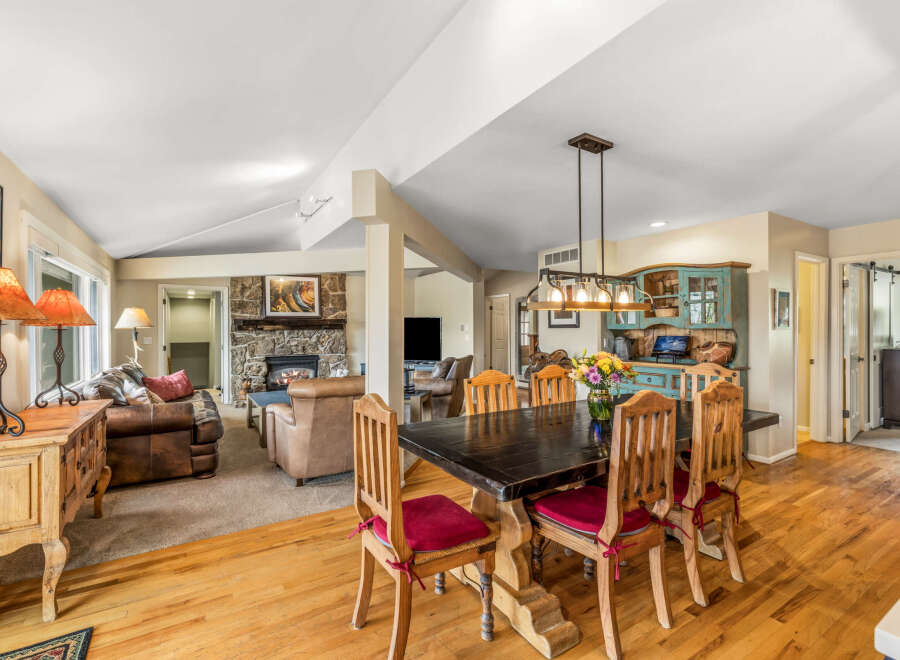Step into this inviting home featuring a cozy living area with a fireplace and a spacious dining area.