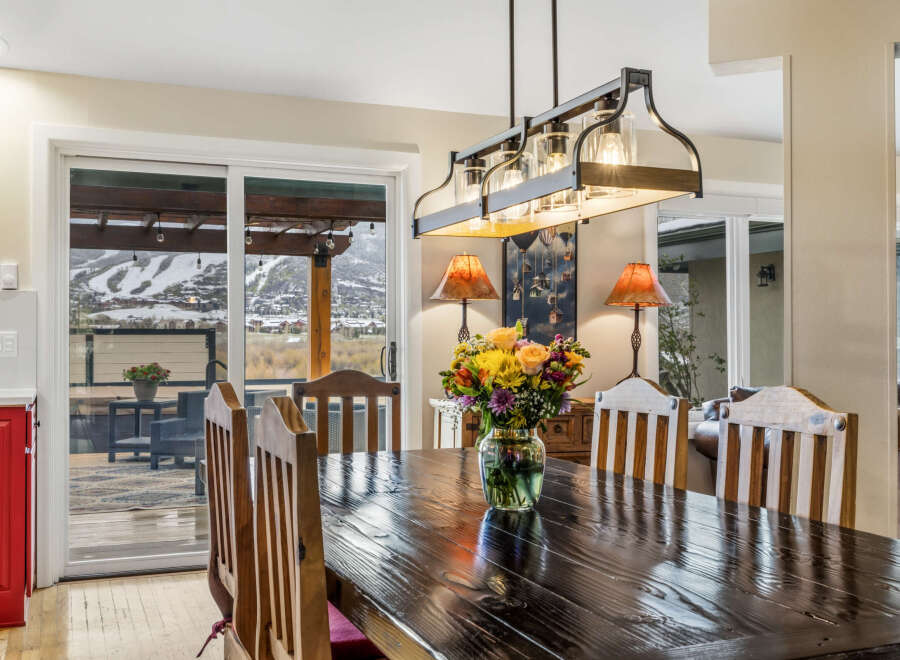 This stunning dining room showcases a beautiful dark wood table, perfect for hosting gatherings.