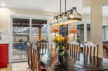 This stunning dining room showcases a beautiful dark wood table, perfect for hosting gatherings.