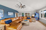 This stunning living room boasts a spacious layout with a comfortable leather sectional sofa, perfect for relaxing and entertaining.