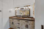 This stunning bathroom boasts a rustic, yet modern design, perfect for a luxurious home.