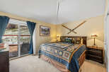 This cozy bedroom features a comfortable bed adorned with a beautiful quilt, creating a warm and inviting atmosphere.