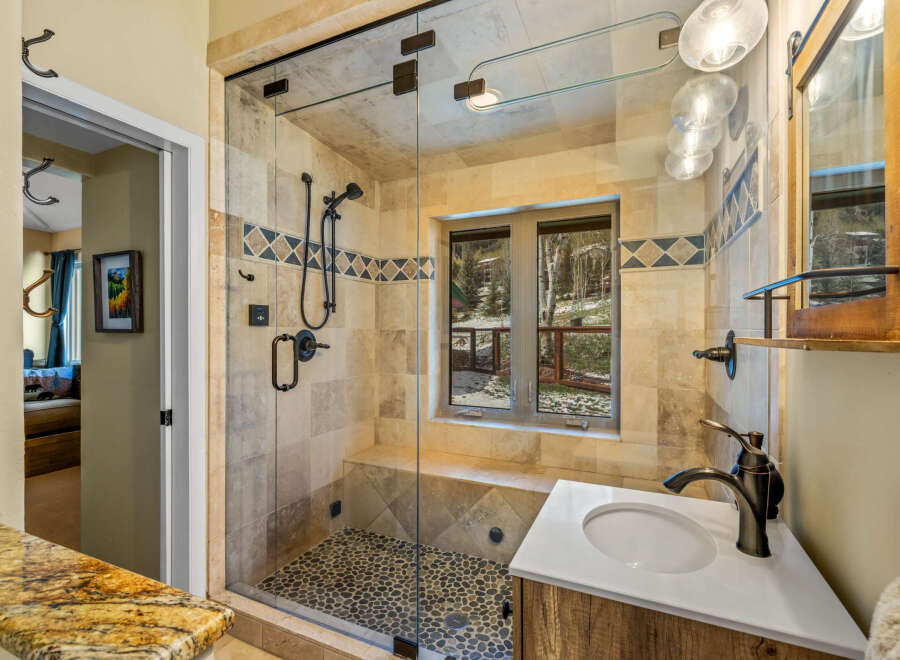 Step into luxury with this stunning bathroom! Featuring a spacious glass shower, a stylish vanity, and a beautiful stone tile design, this bathroom is the perfect blend of elegance and functionality.