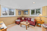 This cozy living room features a comfortable red leather sectional sofa, perfect for relaxing.