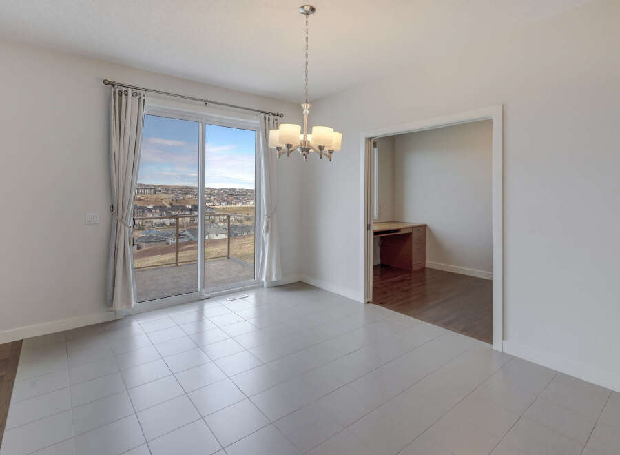 This bright and airy dining area features a stunning view through large sliding glass doors.